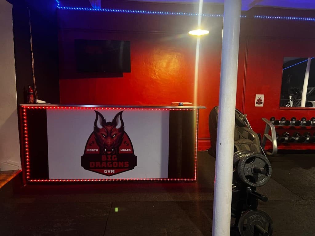 Big Dragons Gym reception desk with logo