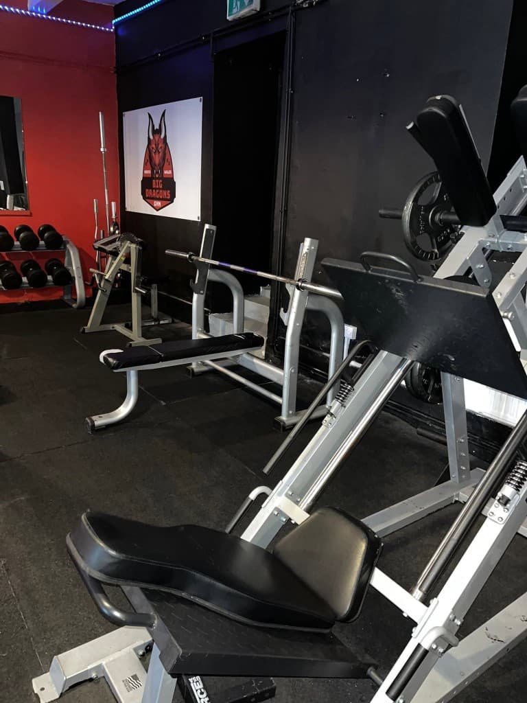 Leg press and bench press stations at Big Dragons Gym